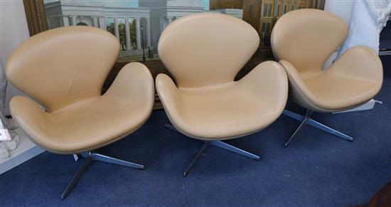 Three Arne Jacobsen designed swan chairs in tan leather